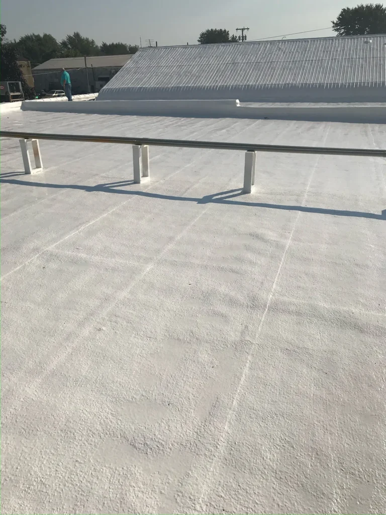White reflective roof coating on a low-slope commercial roof